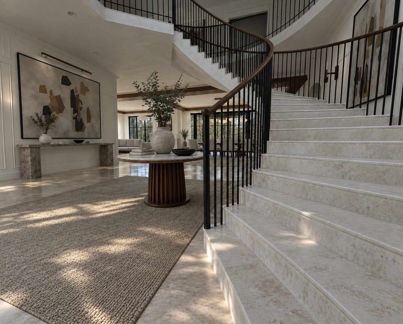 Light-filled entry with a curved stone staircase, dark metal railing, and round wood table
